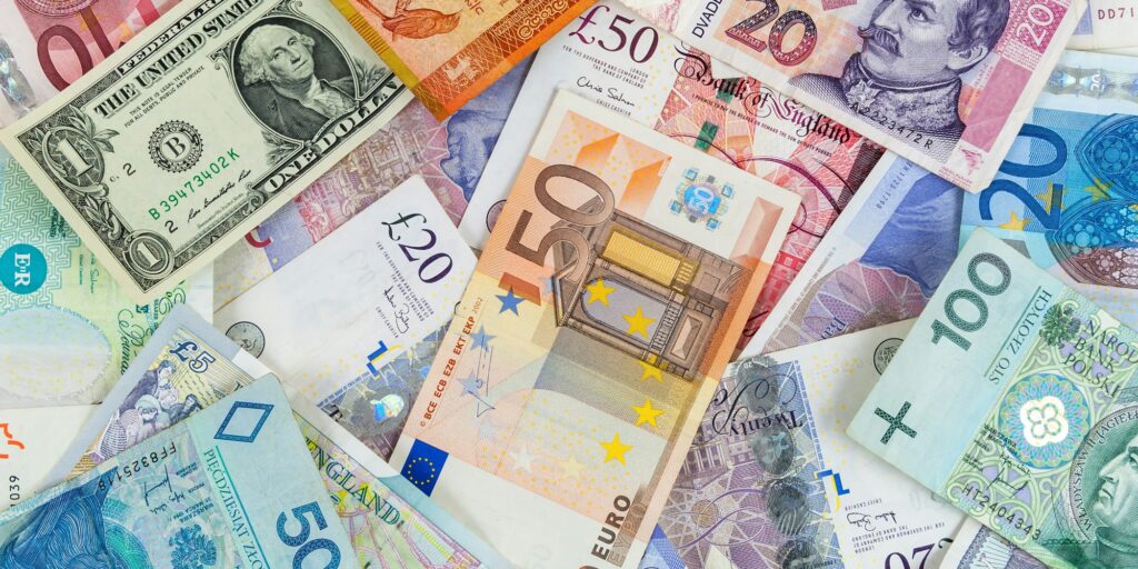 Different currencies banknotes background