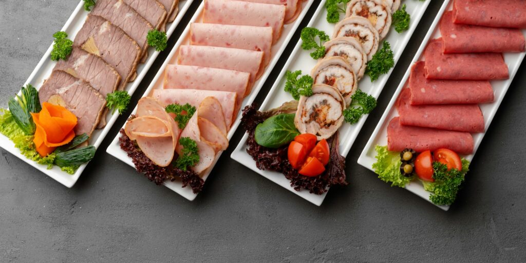 Platter of fresh meat cold cuts on table