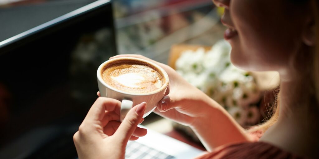 Woman Drinking Coffee in Coffeeshop