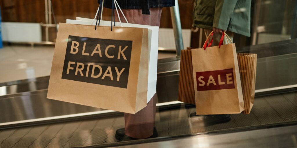 People Holding Black Friday Shopping Bags