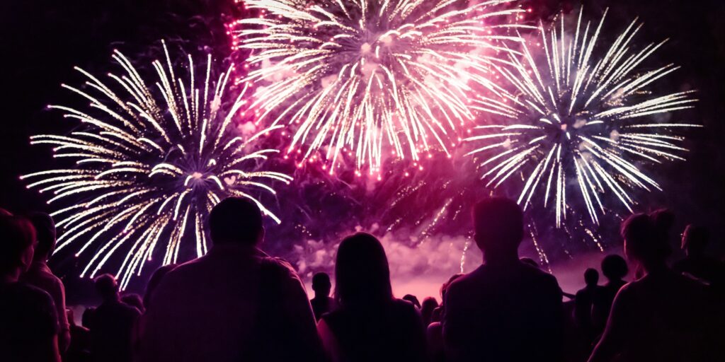 Crowd watching fireworks and celebrating new year eve