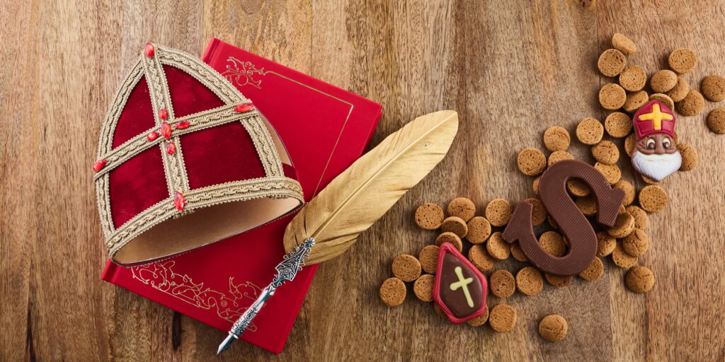 Dutch holiday Sinterklaas background with mitre or mijter staff and book of Sinterklaas.