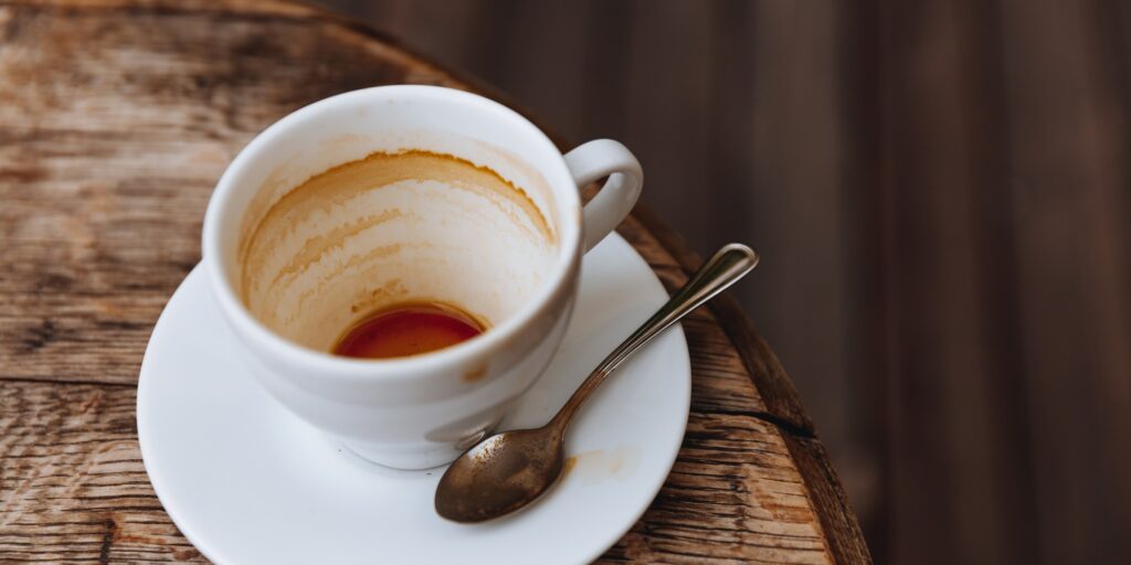 Empty hot coffee in white ceramic cup on wooden table