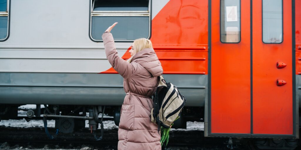 girl on the station platform waving