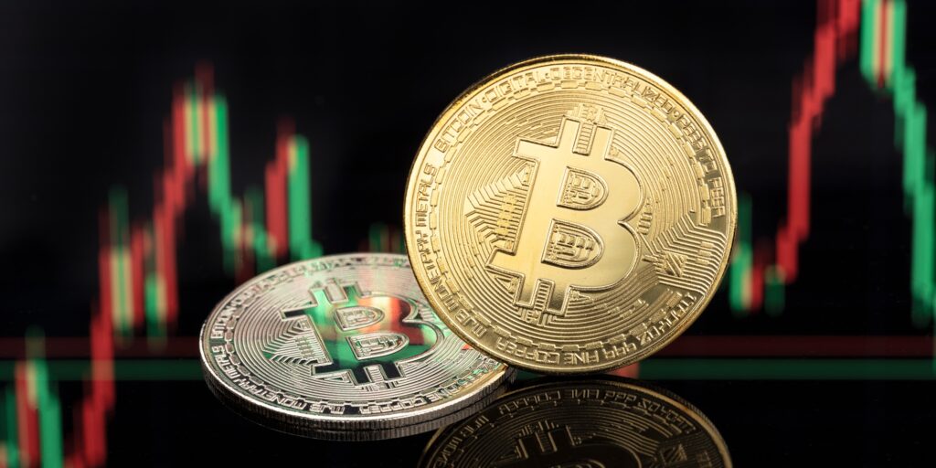 Bitcoin coins on stock chart background