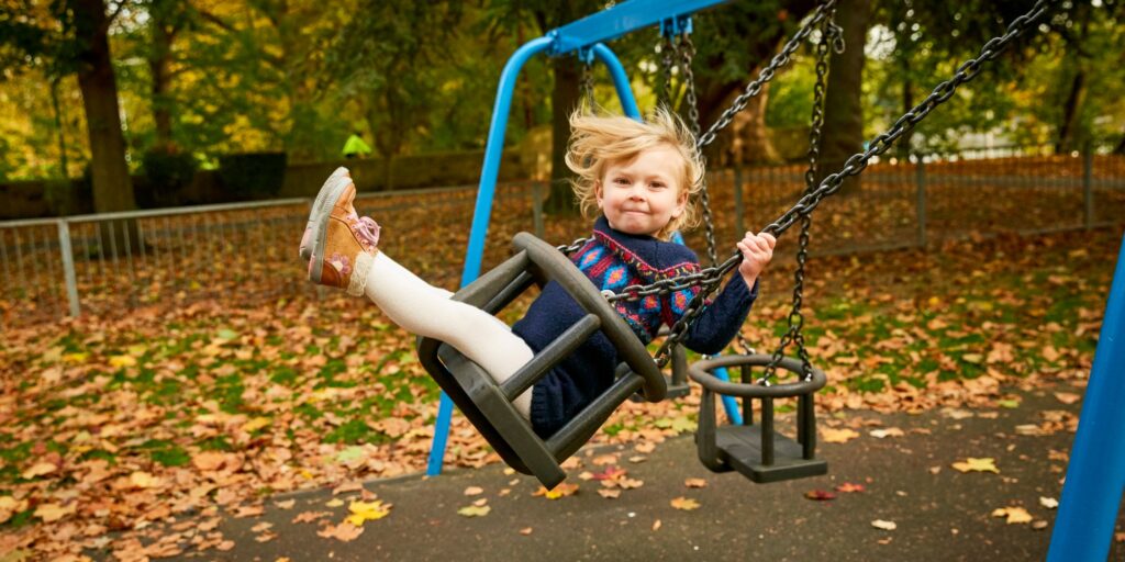 Girl swinging on playground swing