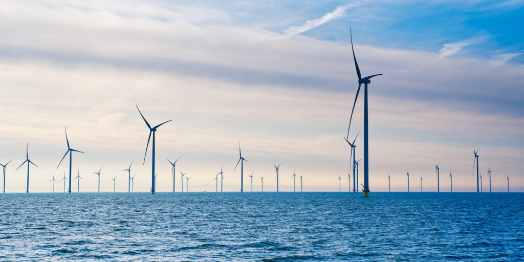 Offshore Windmill farm. windmills isolated at sea on a beautiful bright day Netherlands