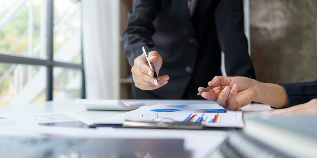 Business people analyzes, graphs and charts to examine and analyze company finances, revenues