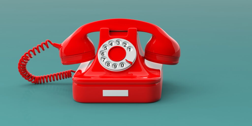 Red vintage telephone isolated on green blue background, copy space, banner.
