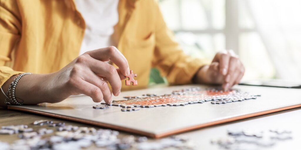 Woman sitting at desk and solving a puzzle