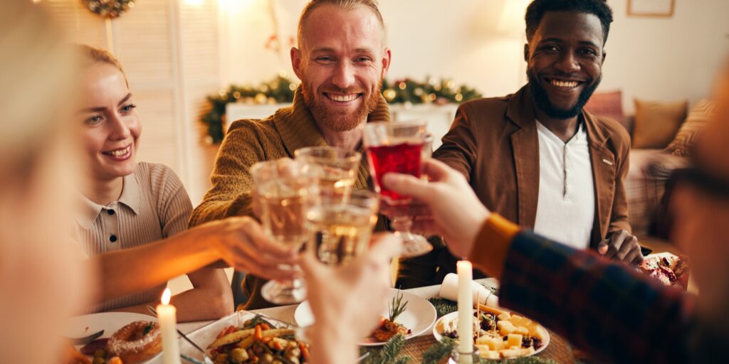 Adult People Raising Glasses at Dinner Party