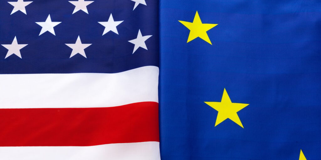 Closeup of Flags of USA and European Union lying together on table