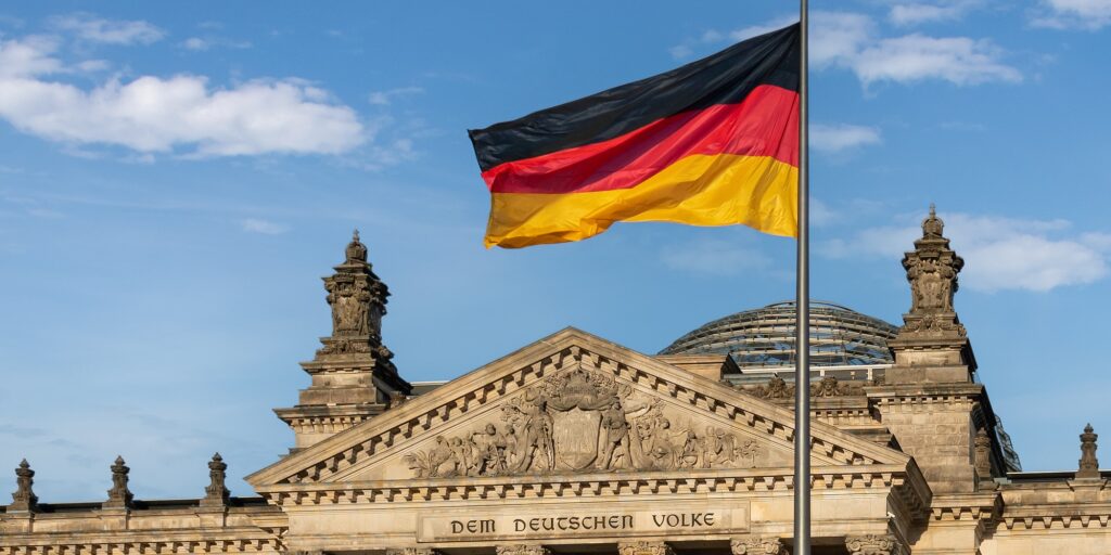 German Flag in front of the German Parliament (Bundestag) - Reichstag Building - Berlin, Germany