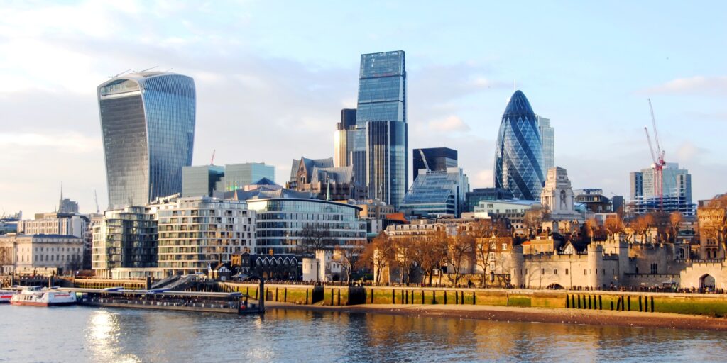 View of the financial district of london from the Thames River at sunset