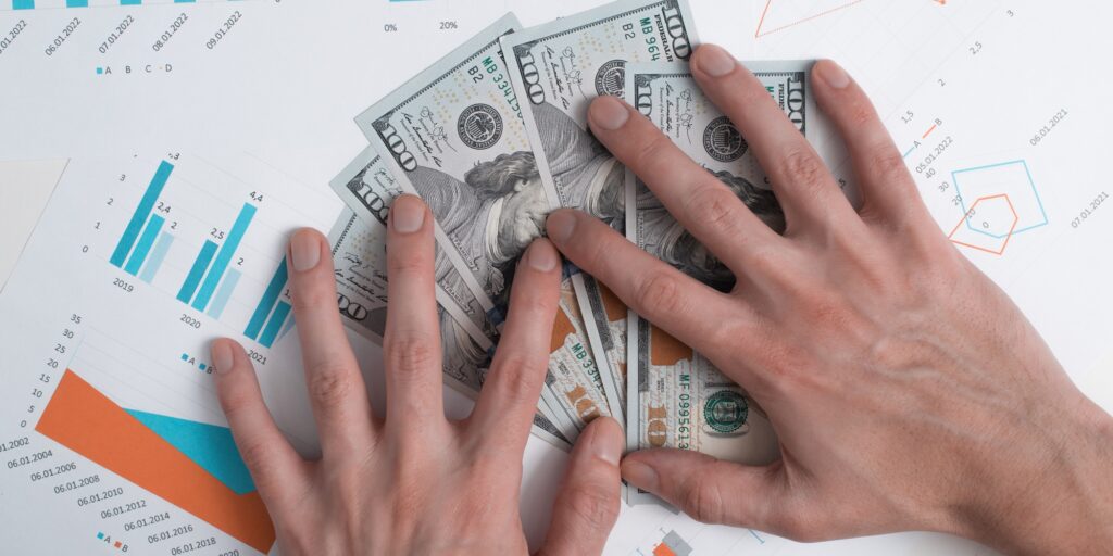 Wealth, business success, greed concept. Close-up of hand holding money dollars on financial