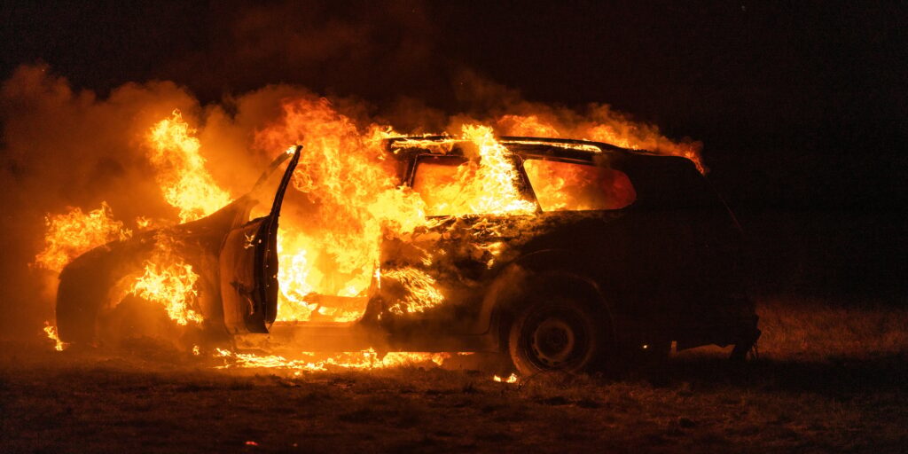 Beautiful shot of a burning car in the desert at night