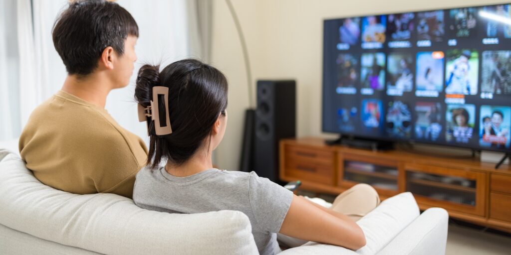 Couple watch TV at home