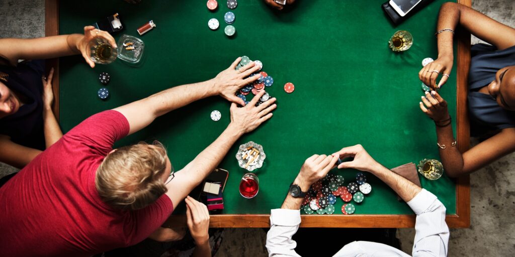 Diverse group playing poker and socialising