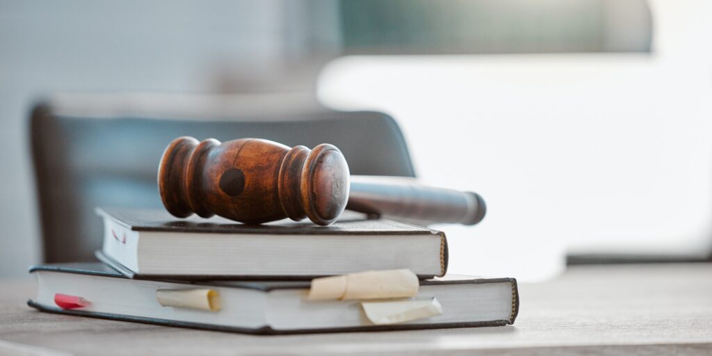 Justice, gavel and law books on table in office for court trial, legislation or fair constitution b