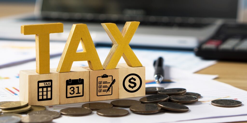 Tax wooden letter and tax icon on wooden block.Pay tax in new year.
