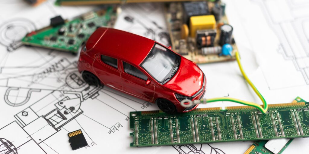 A photograph that expresses the image of a Connected Autonomous Vehicle using a motherboard.