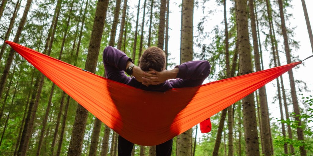 happy man in hammock in the middle of the forest