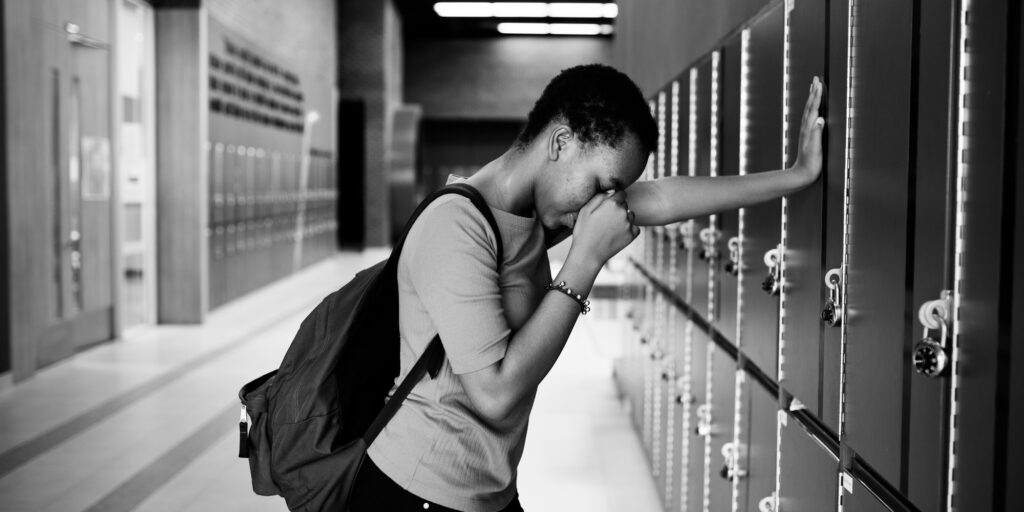 Young sad student on the hallway