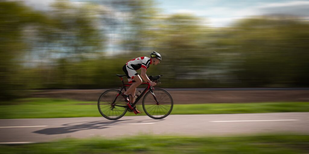 Cyclist rides on bicycle, speed effect, side view