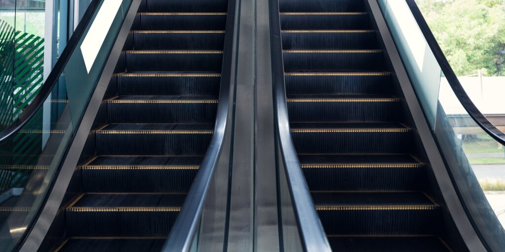 Electric escalators with railing moving up and down