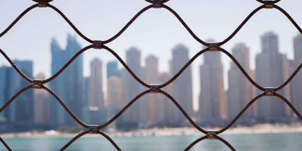 View of the skyscrapers in Dubai through the iron bars.